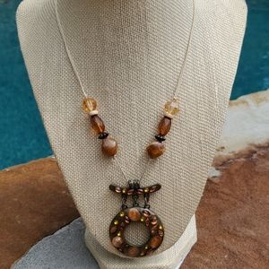 Tan thread necklace with Brown beads and Charm.